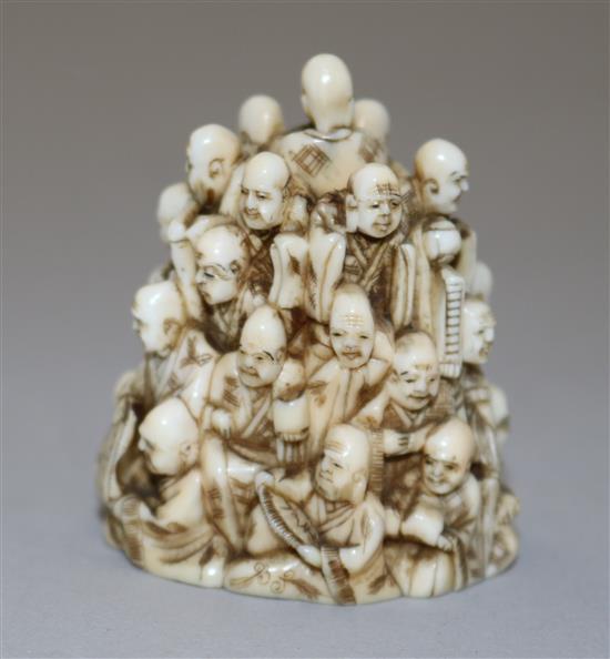 A Japanese ivory netsuke of multiple rakan, Meiji period, height 5.6cm